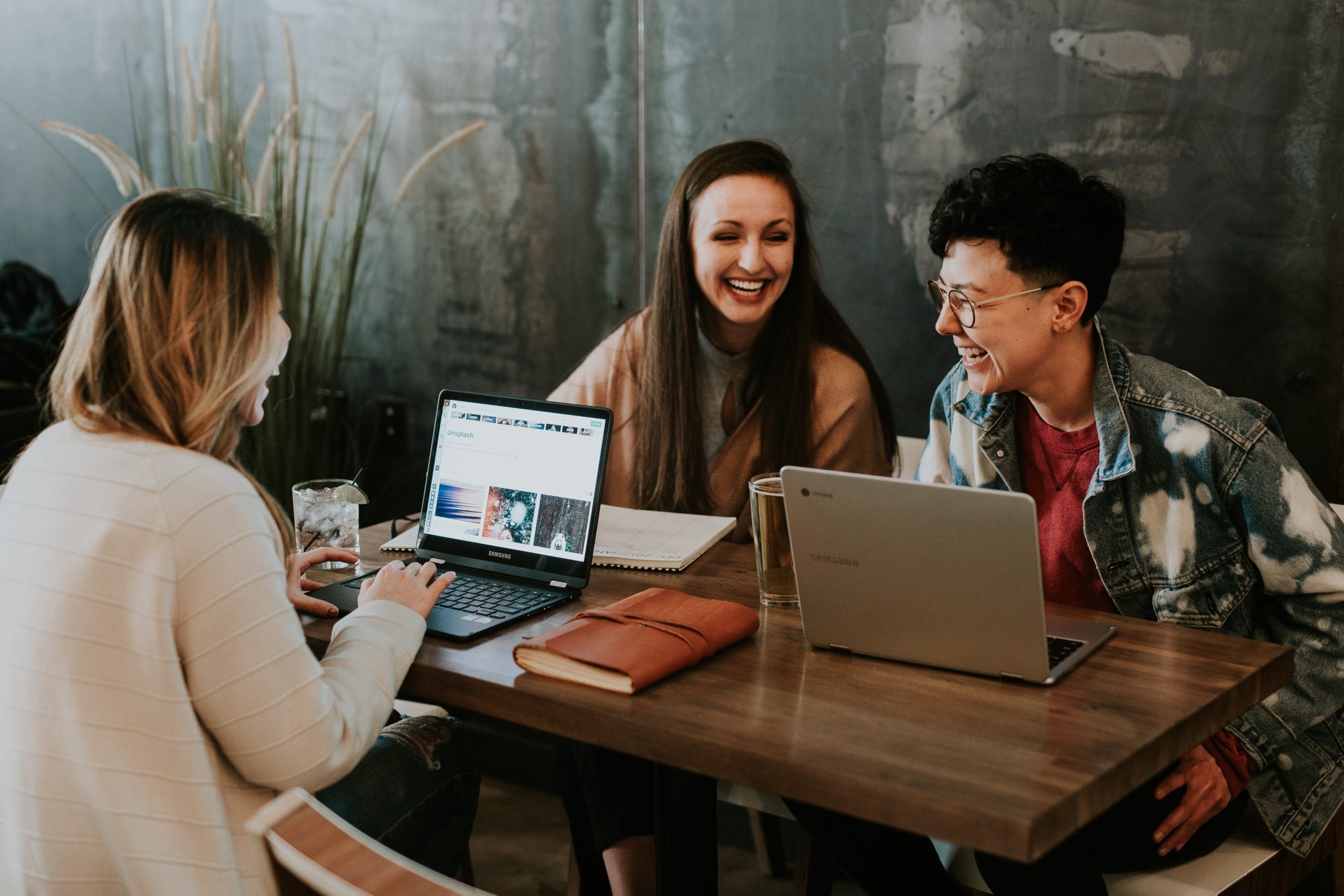 Putnam Associates Interview. Image shows 3 woman working together at a cafe.
